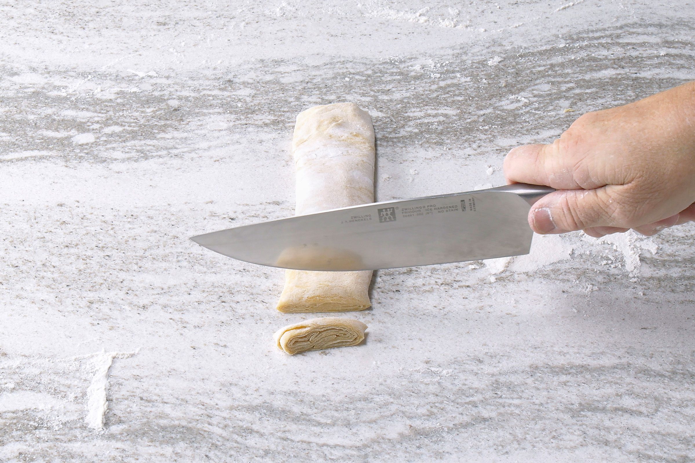 Cutting the rolled up dough into thin slices