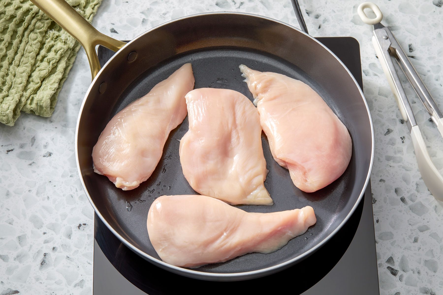 chicken breasts arranged in a pan