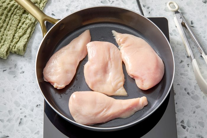chicken breasts arranged in a pan