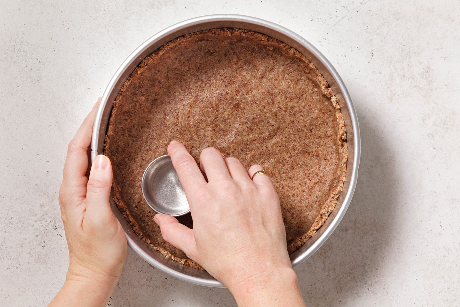 Press mixture into the bottom of a springform pan.