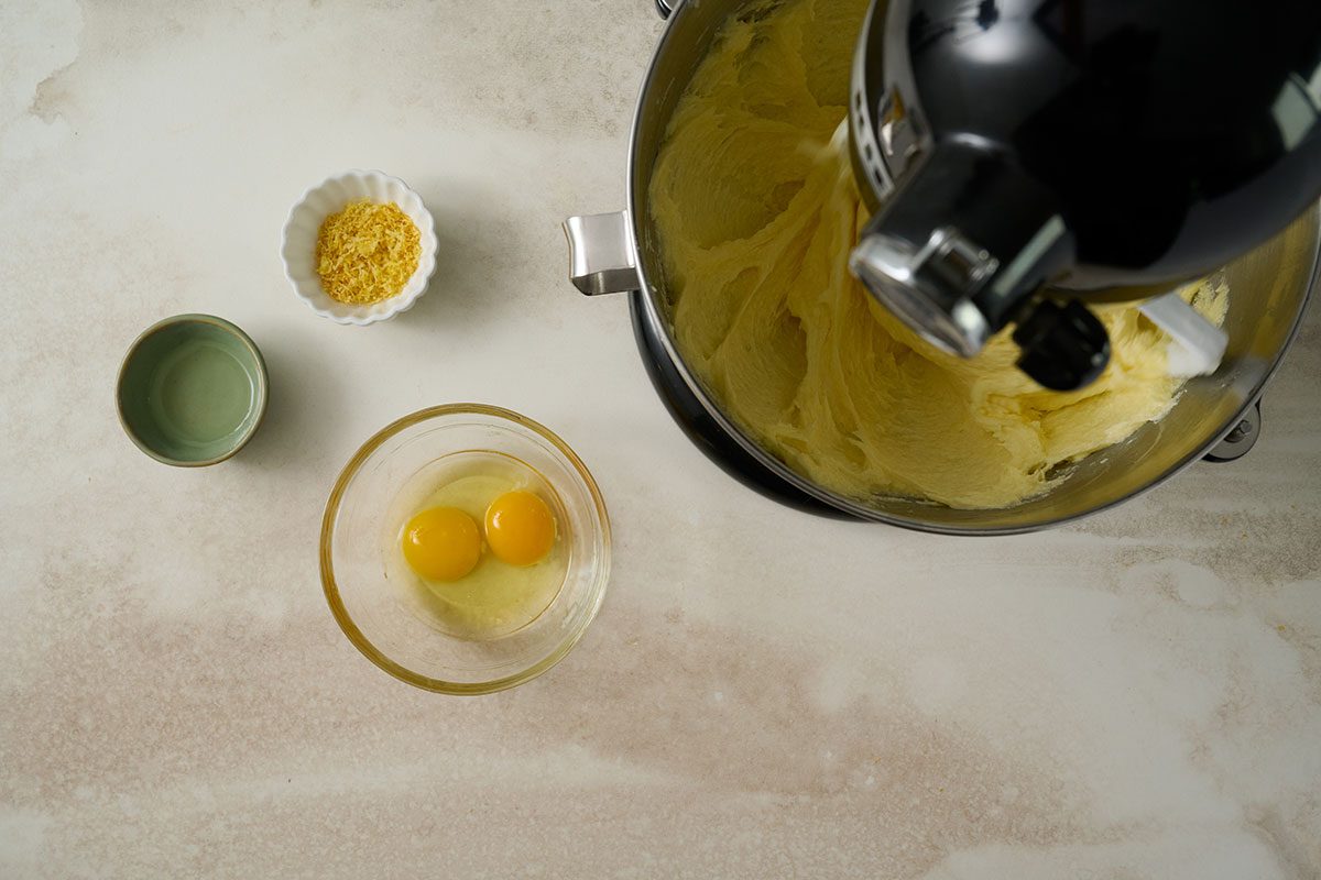 Overhead view of eggs, lemon zest, and lemon extract are gradually incorporated into the batter for Taste of Home Lemon Pound Cake Recipe.