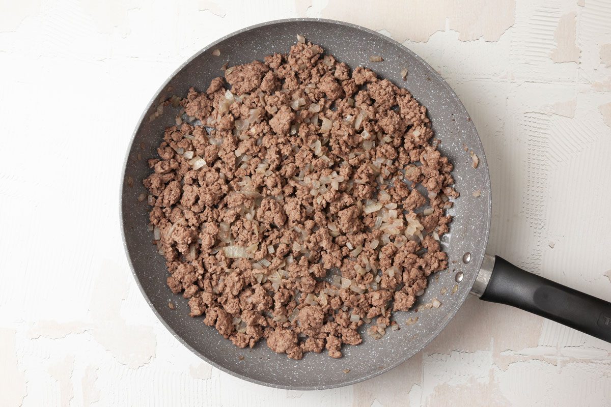 Step 1 of Taste of Home Mexi-Mac Skillet is to brown the meat and onion