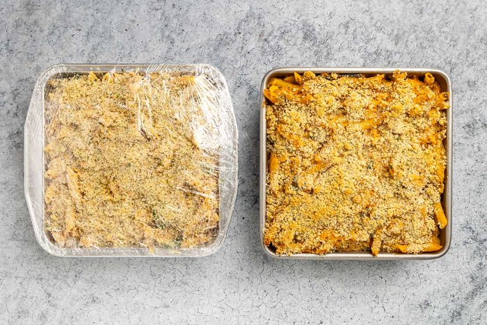 Taste of Home Pesto Chicken Casserole recipe photo of one baked casserole and one casserole prepared for the freezer.