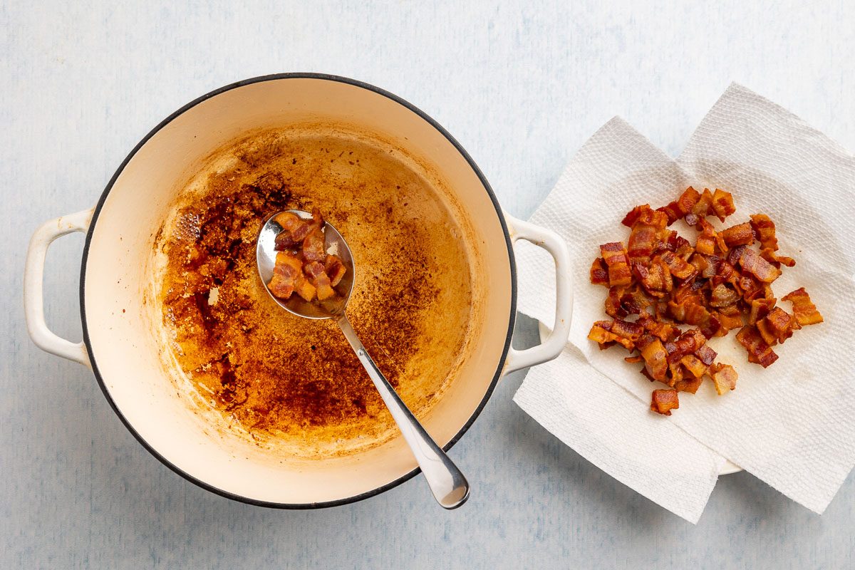 Taste of Home Pinto Bean Recipe photo of crisped bacon coming out of a dutch oven.