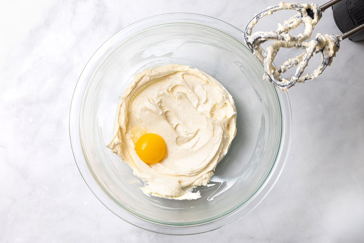Beaten cream cheese mixture with an egg yolk before it gets mixed for step one of Puff Pastry Danish recipe for Taste of Home
