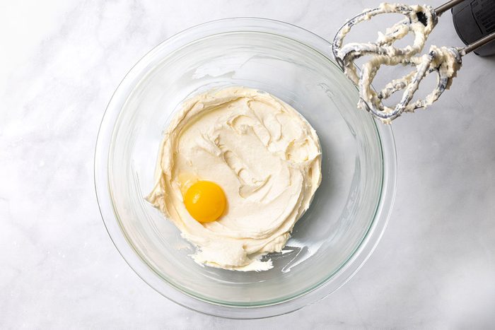 Beaten cream cheese mixture with an egg yolk before it gets mixed for step one of Puff Pastry Danish recipe for Taste of Home
