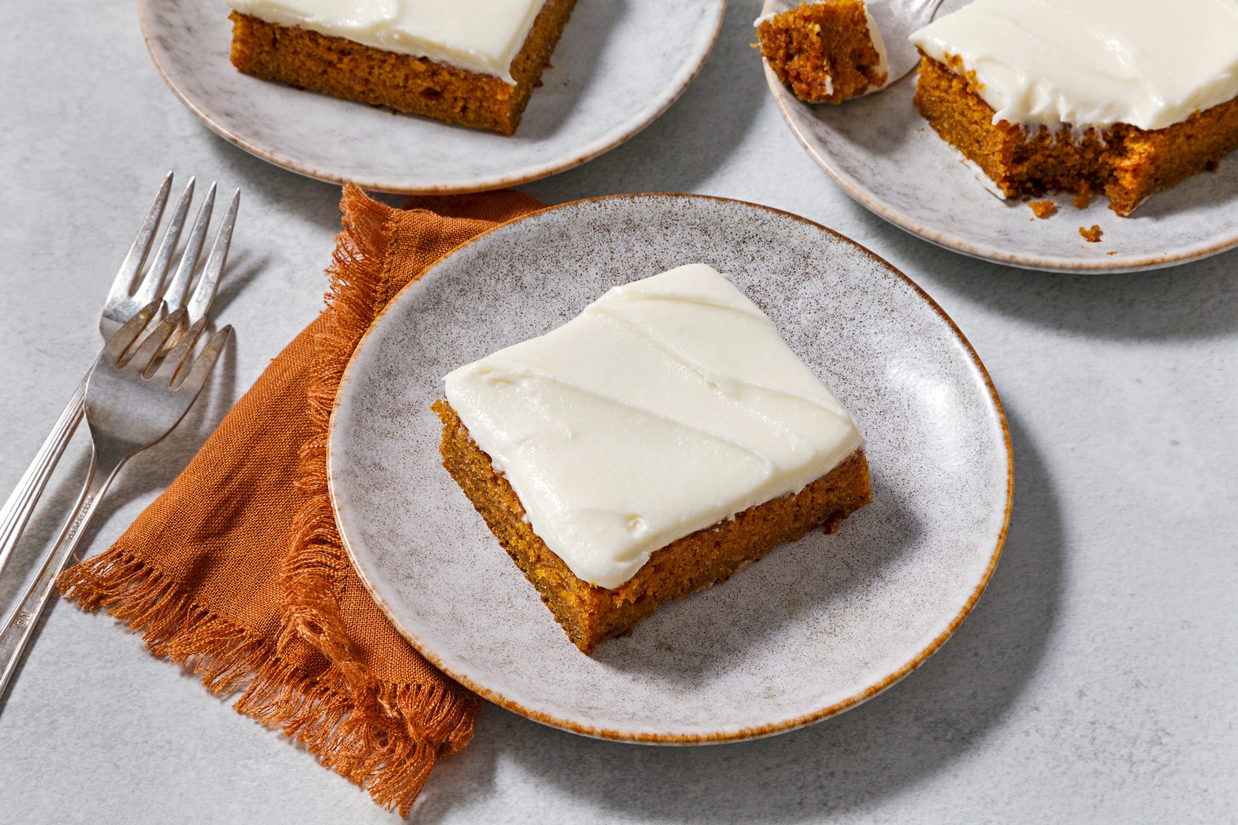 3/4th angle shot of Pumpkin Spice Cake with Cream Cheese Frosting.