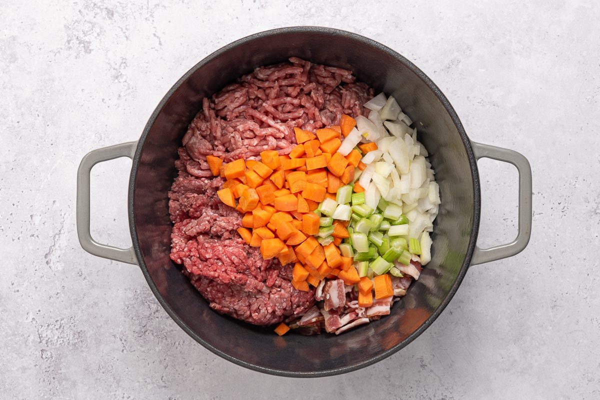 Beef, Pork, Bacon, Onion, Celery And Carrot Inside Dutch Oven
