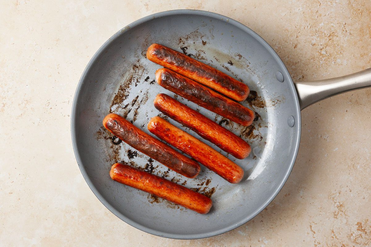 Step 2 of Taste of Home Rhode Island Hot Dogs is to cook the hot dogs