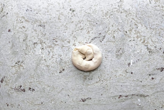 Dough shaped into a coil after being rolled up.
