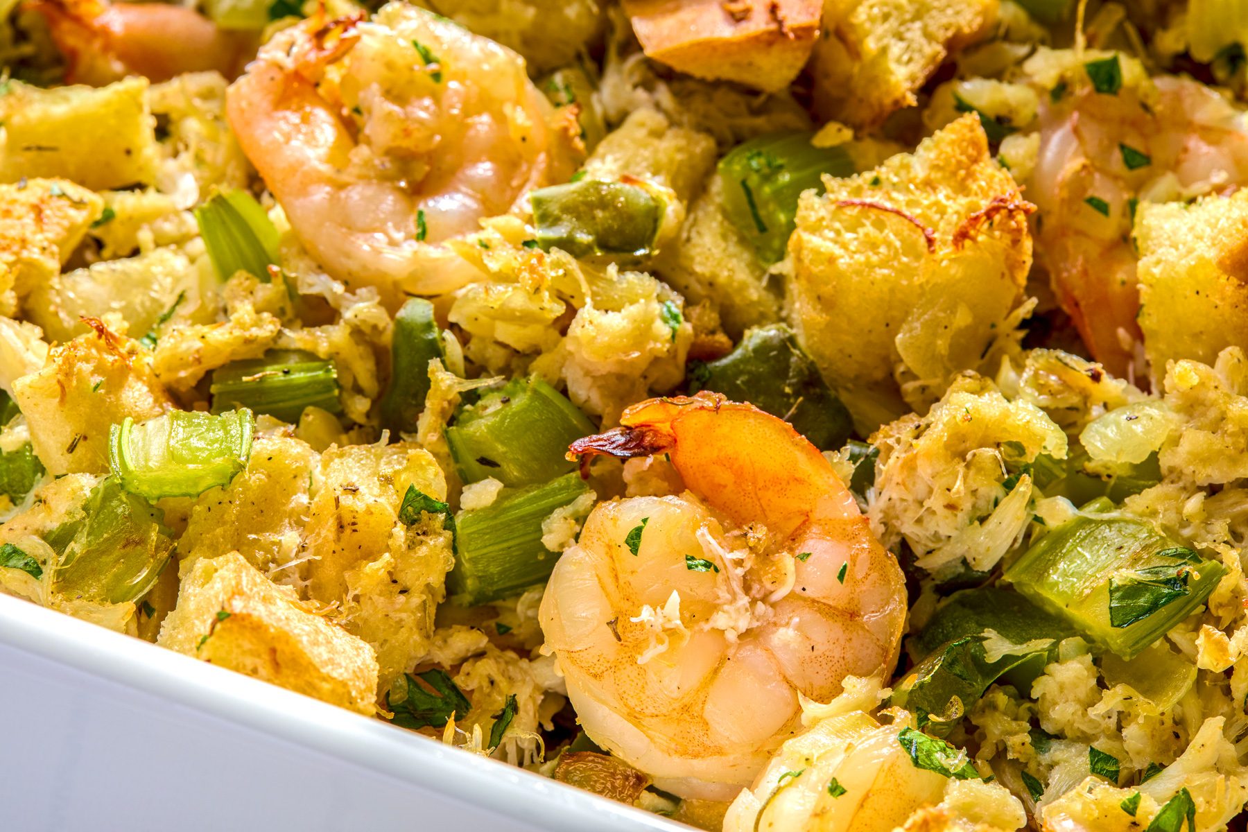 close shot of a white baking dish filled with a seafood stuffing