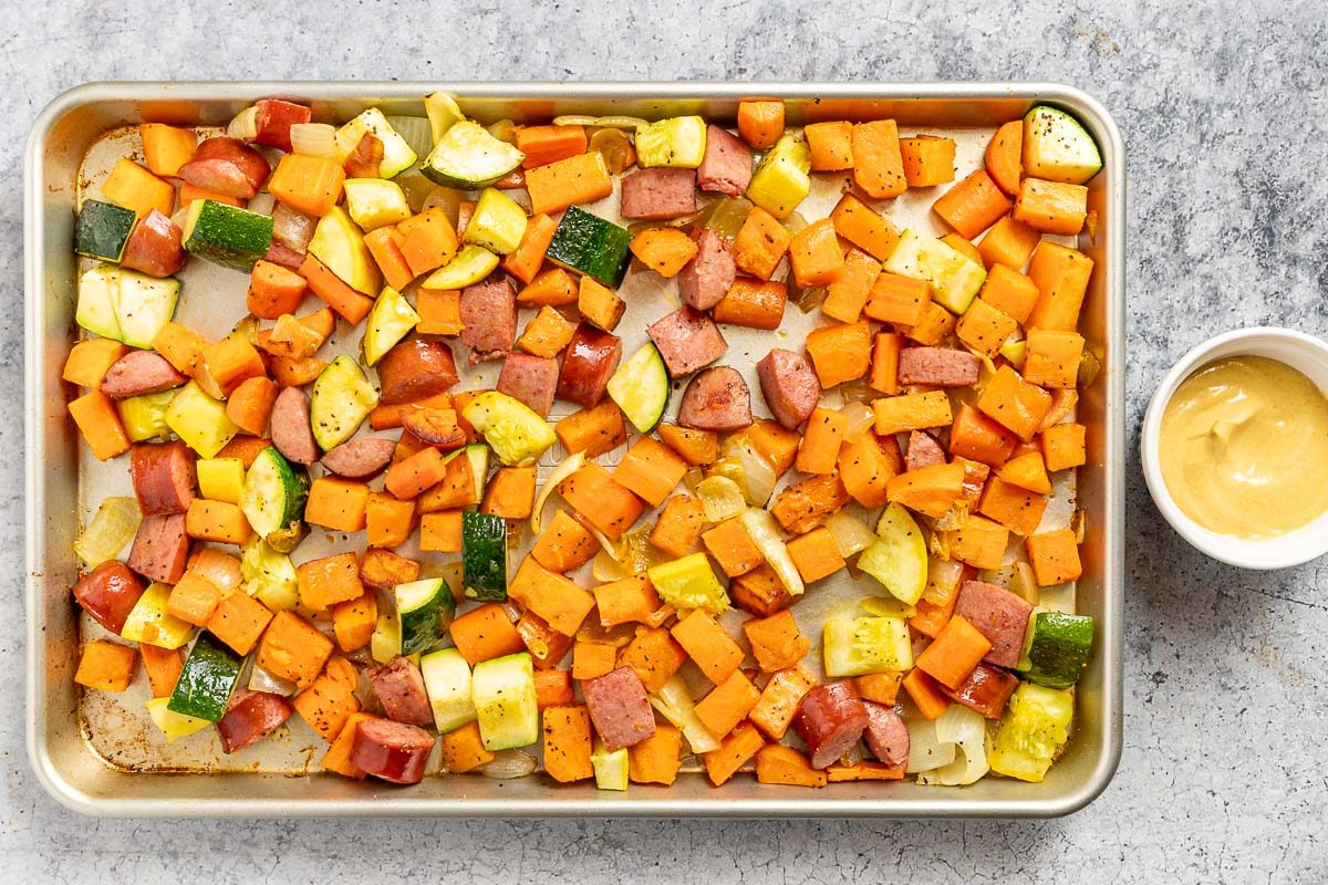 Taste of Home Sheet Pan Kielbasa and Veggies photo of the roasted root veggies with the kielbasa and remaining veggies.