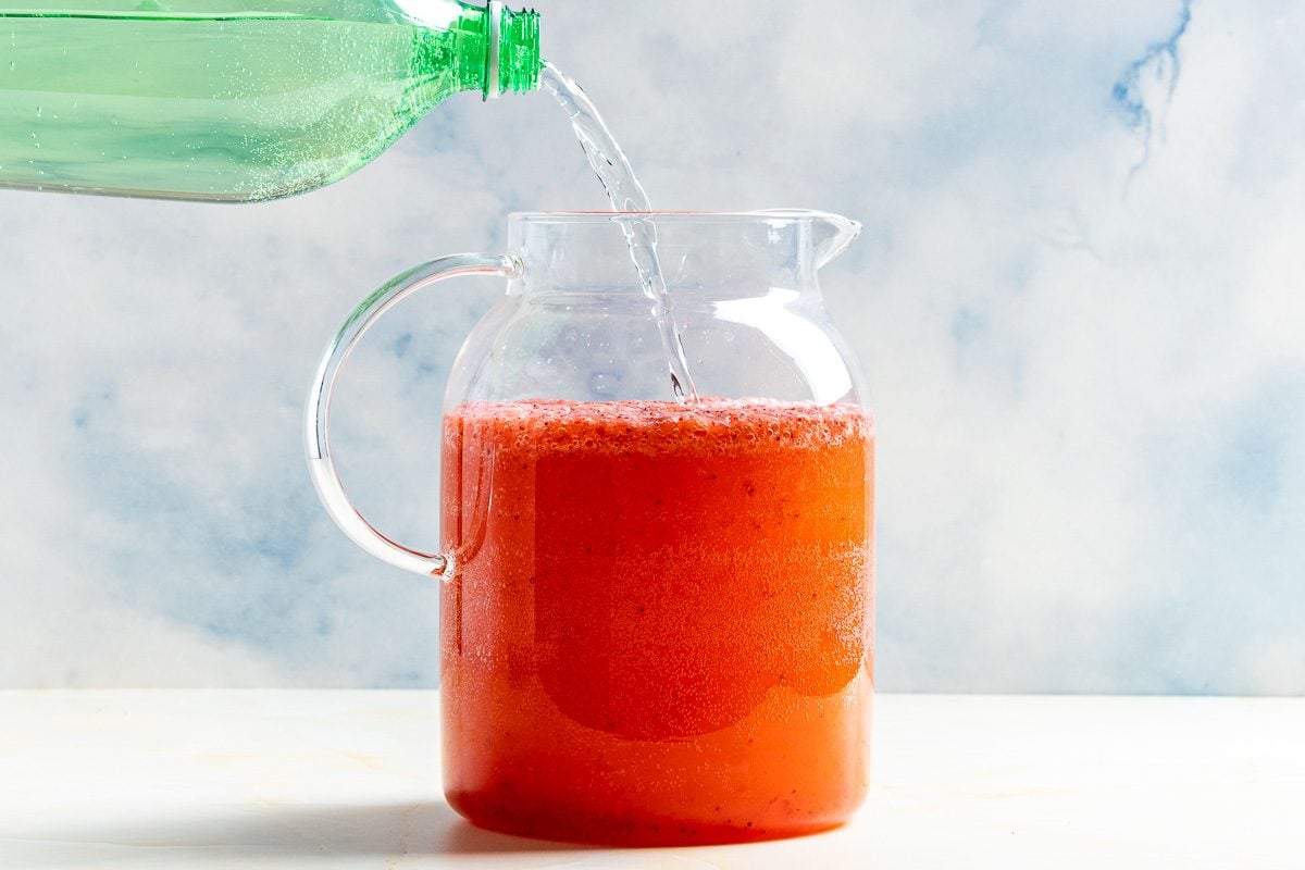 Taste of Home Sprite and Strawberry Drink photo of combining all the ingredients in a pitcher.