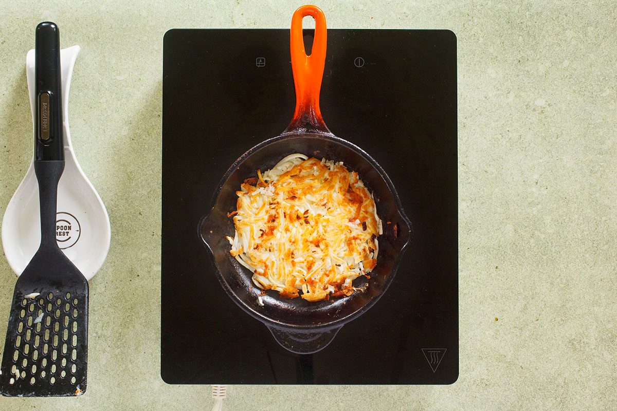 Hash browns flipped on skillet