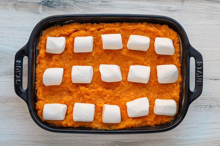 Sweet potato and pineapple casserole topped with marshmallows and ready to bake.
