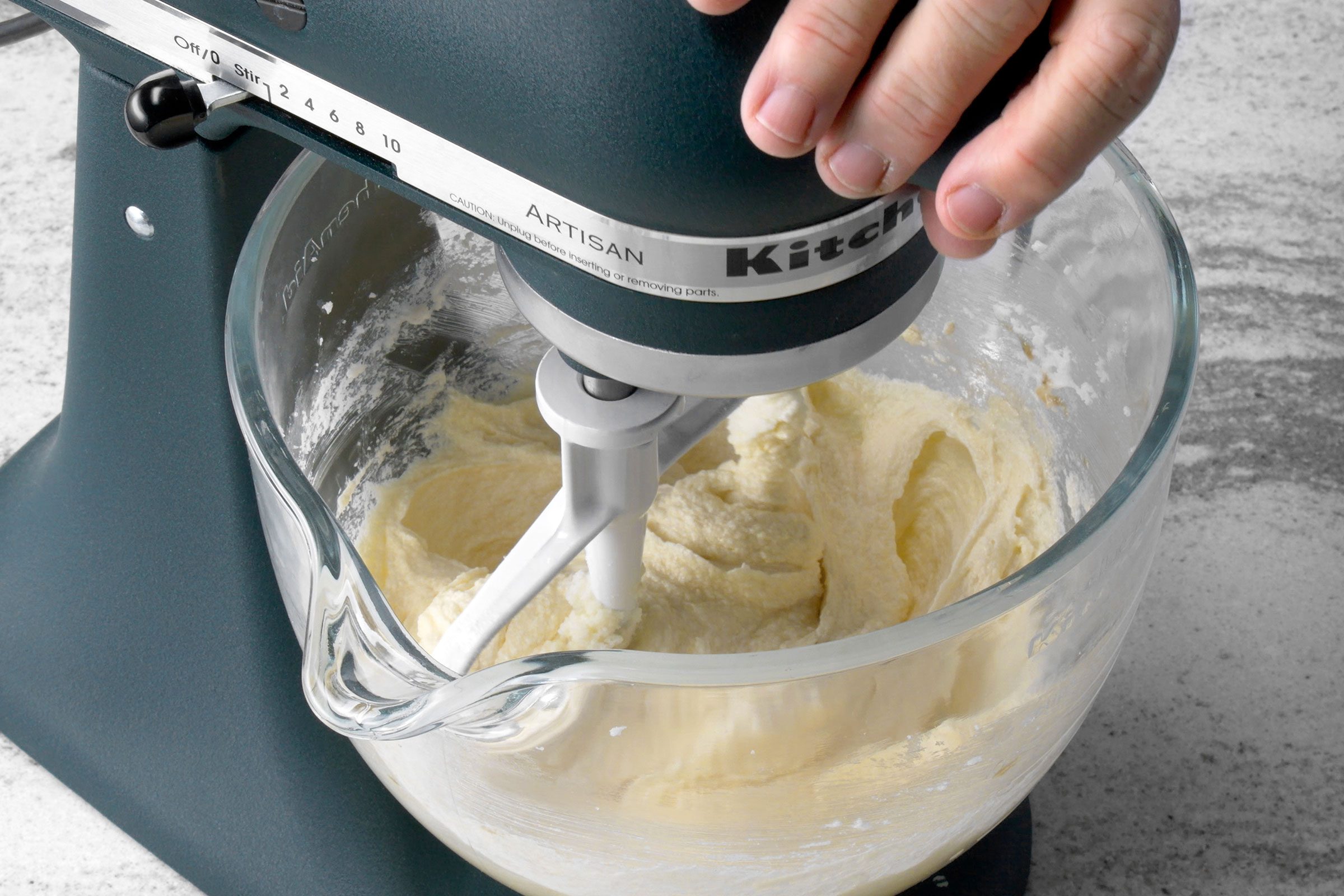Butter and sugar mixed in a large bowl in a mixer