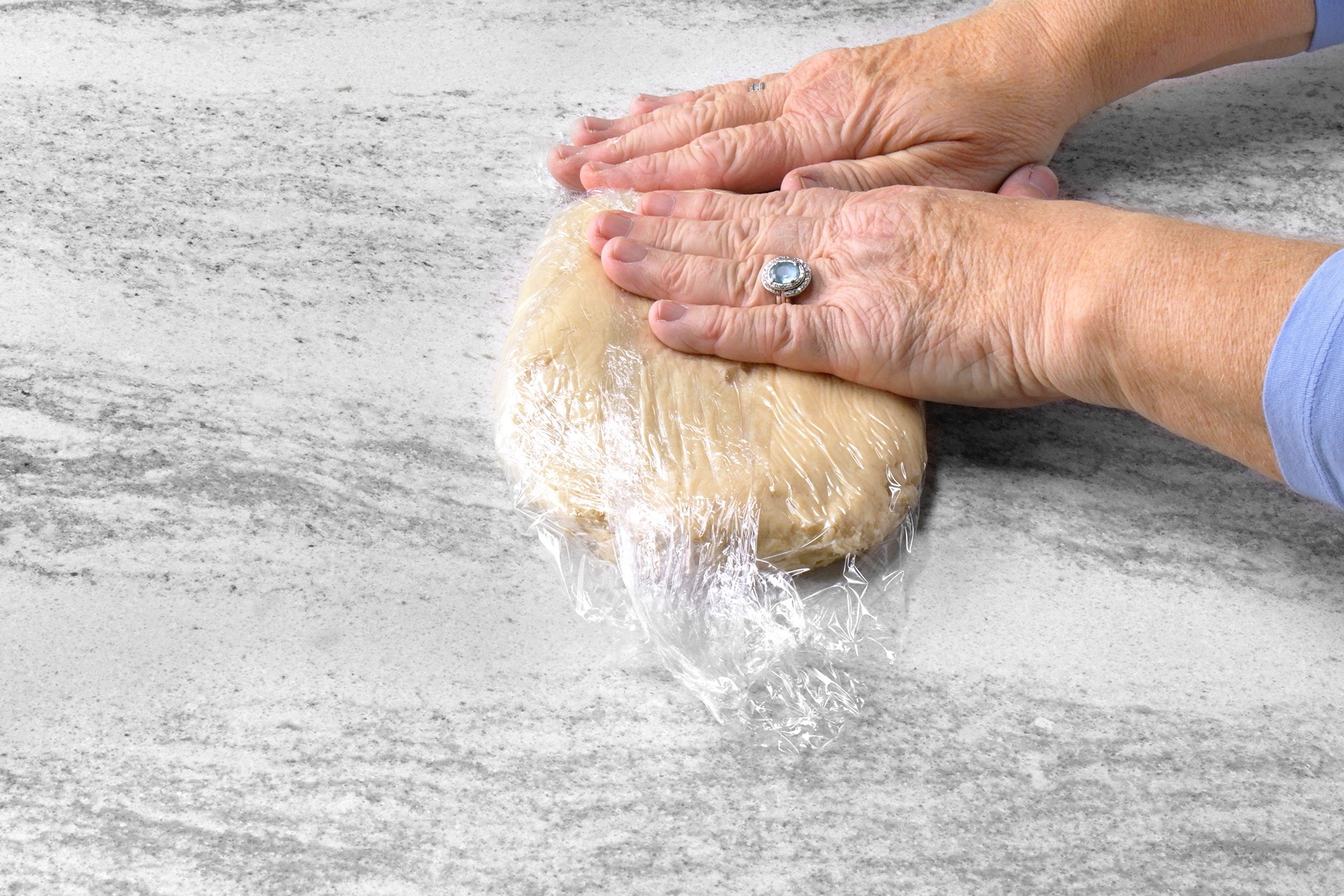 Cookie dough tightly wrapped in a storage wrap on kitchen counter