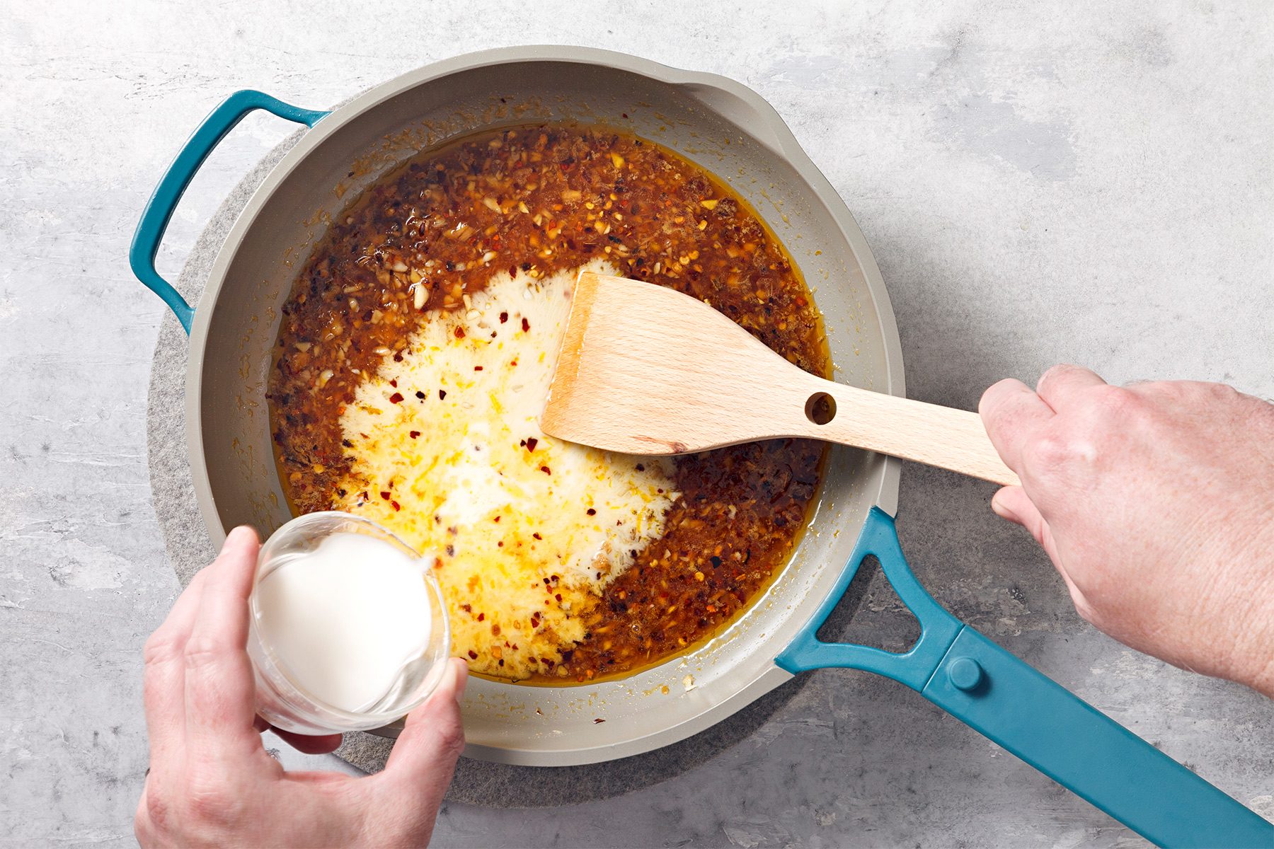 Heat canola oil in a large skillet to medium-high heat. Add red pepper flakes, garlic and ginger;