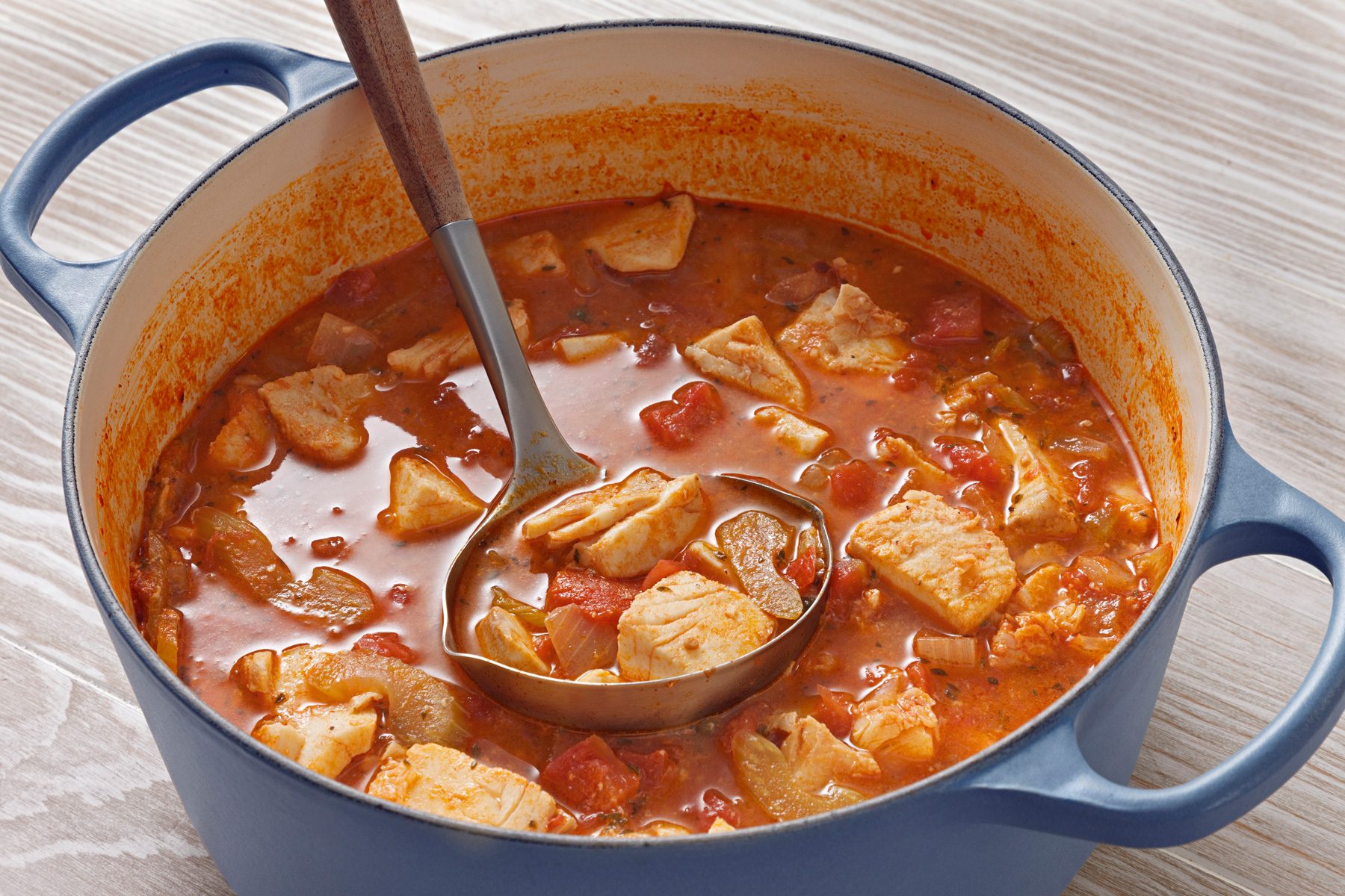 3/4th shot of fish stew in a dutch oven
