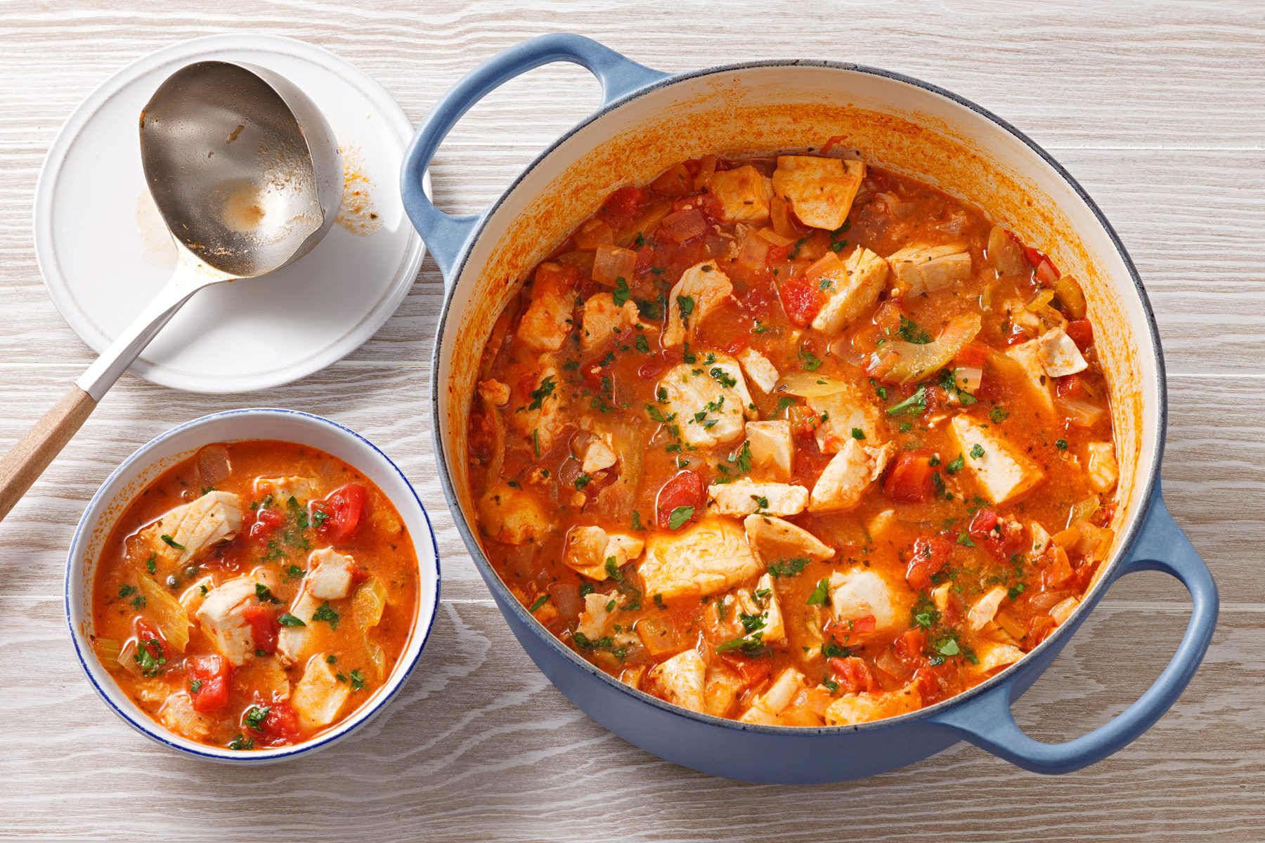 3/4th shot of fish stew in a dutch oven