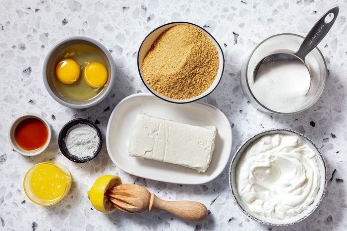Graham cracker crumbs, sugar, butter, eggs, yogurt, lemon juice, vanilla extract and cornstarch.