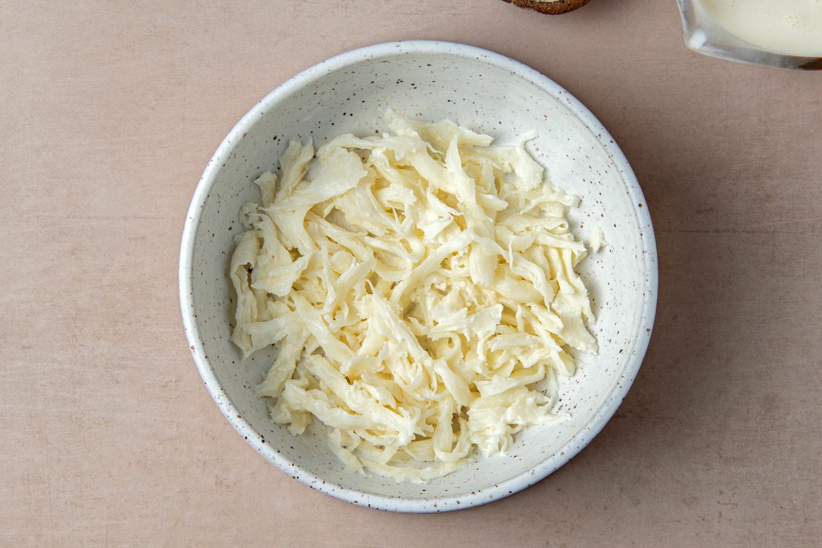 torn pieces of curd in a bowl