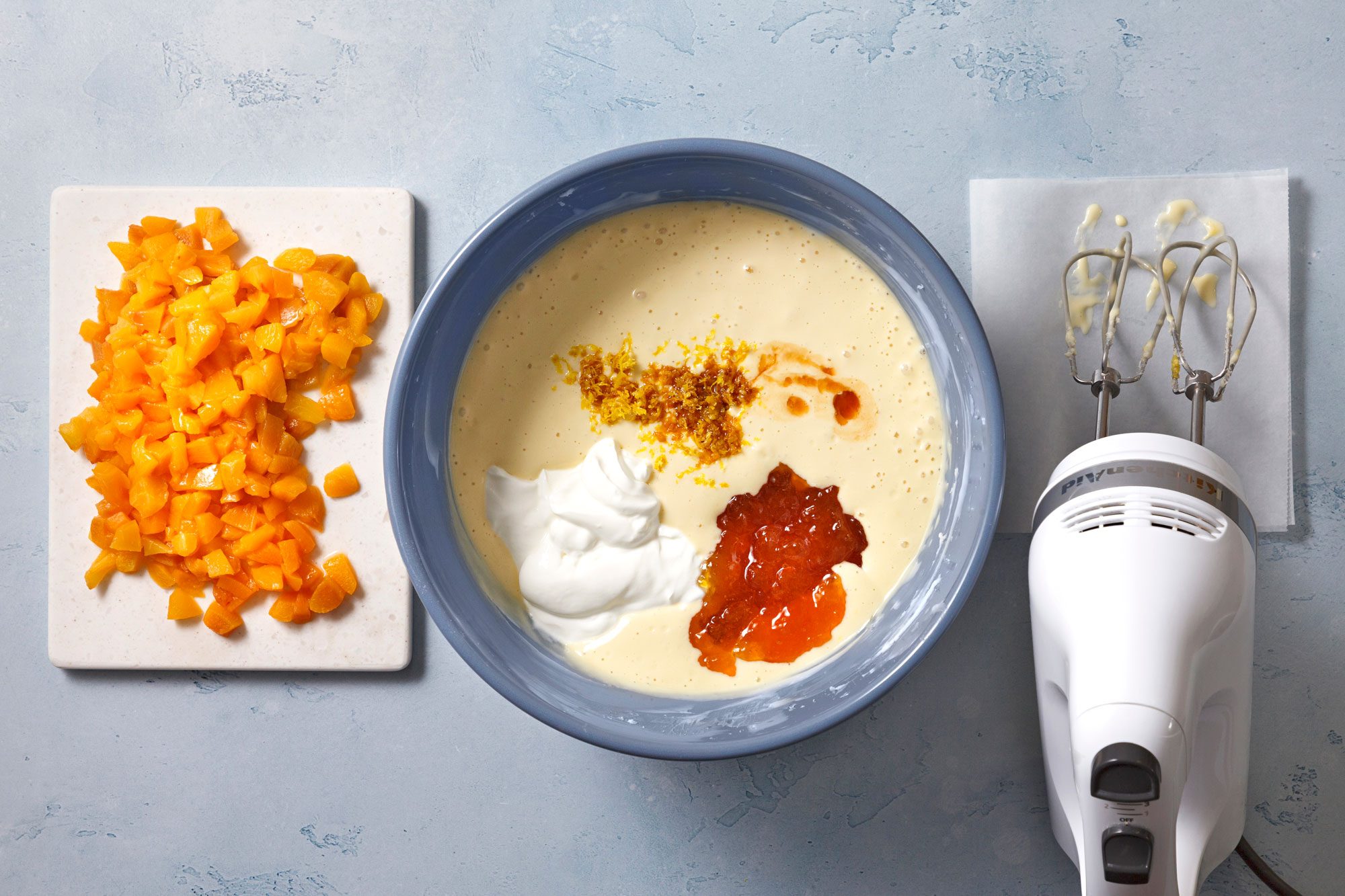 Beat in sour cream, peach preserves, lemon zest and vanilla until smooth and fluffy,