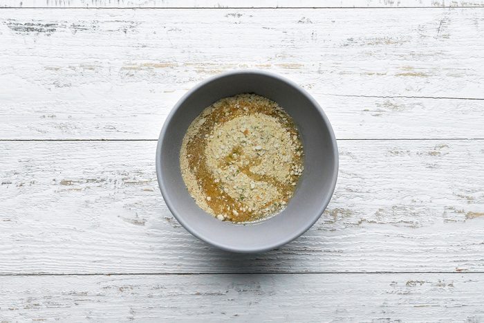 Bread crumbs and oil tossed in together in a small bowl