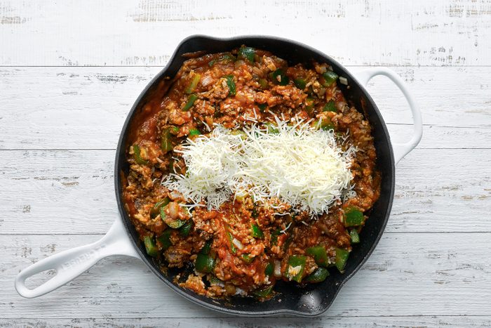 Cooked beef, rice, peppers and onions mixed together with grated cheese on top
