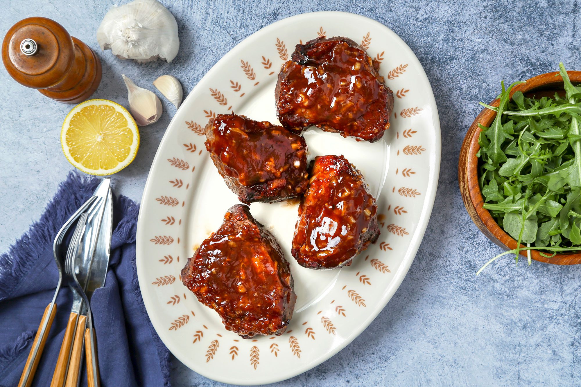 Steak with sauce on a serving platter.