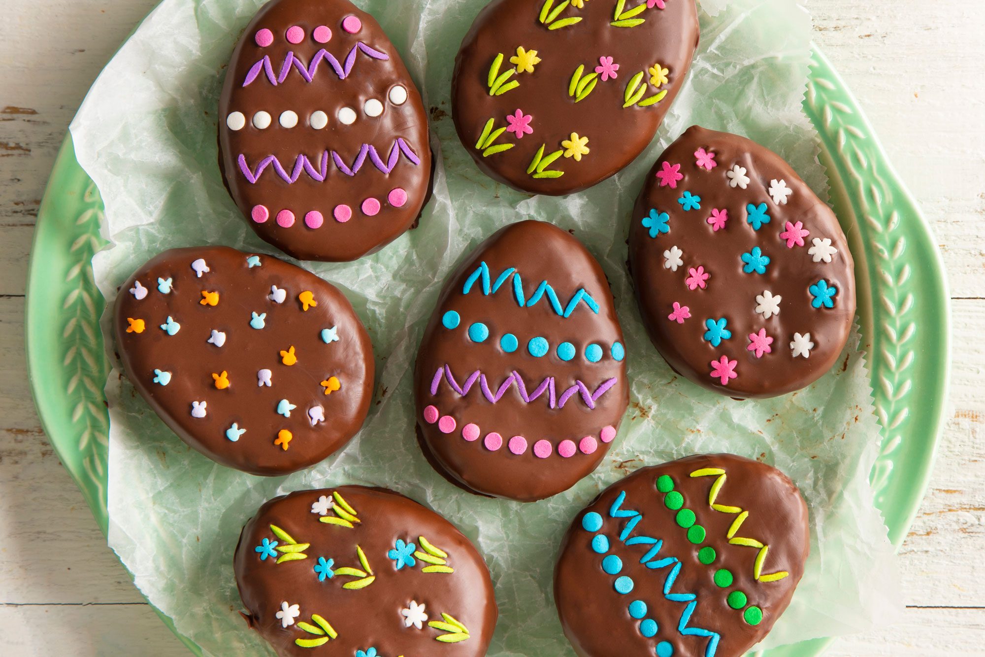 A green plate filled with delicious chocolate-covered Easter eggs