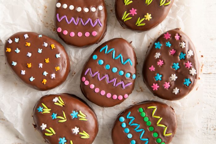 Delicious chocolate-covered Easter eggs on a baking sheet