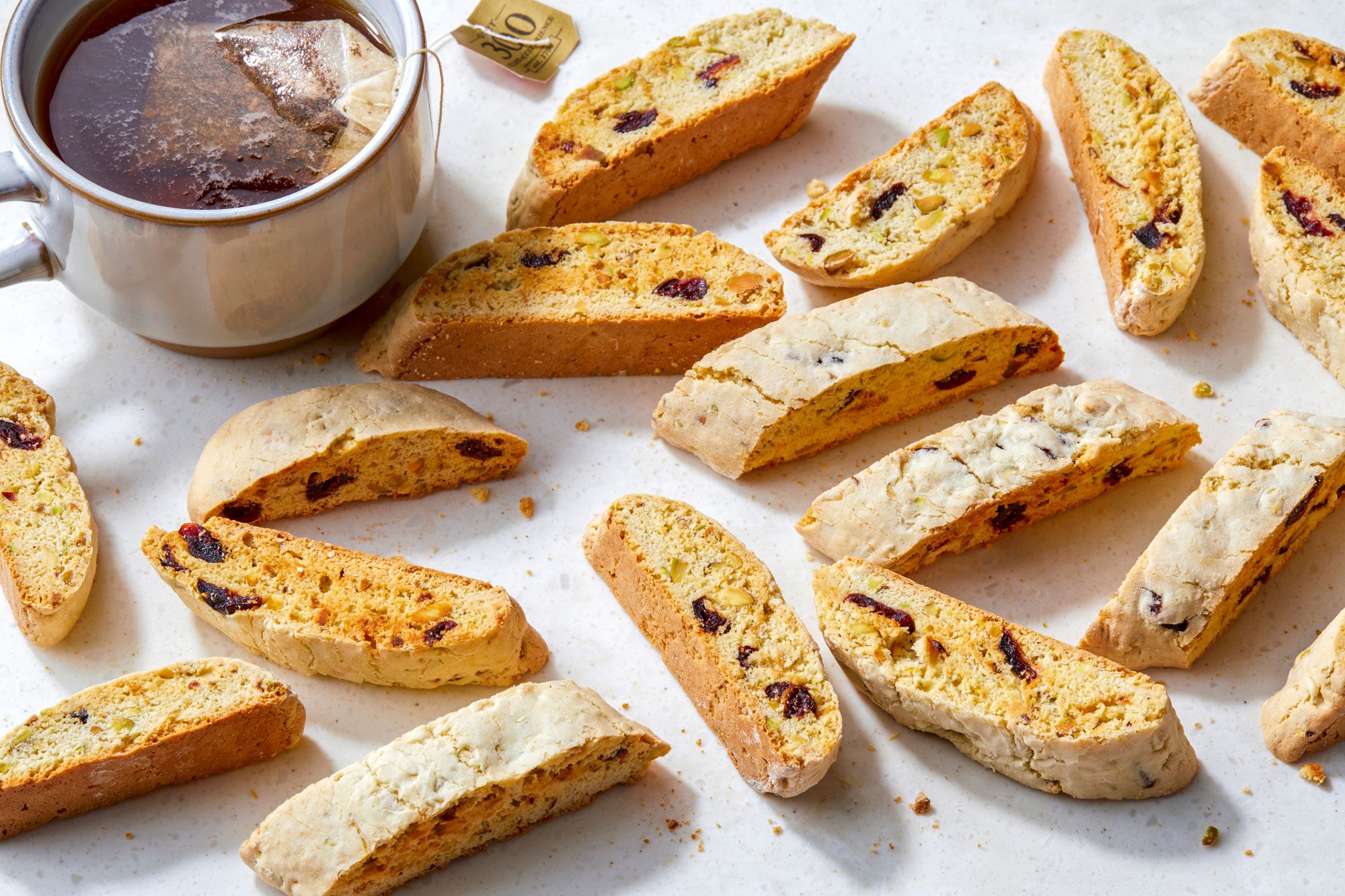 Cranberry and Pistachio Biscotti; serve on cutting board; a cup of tea