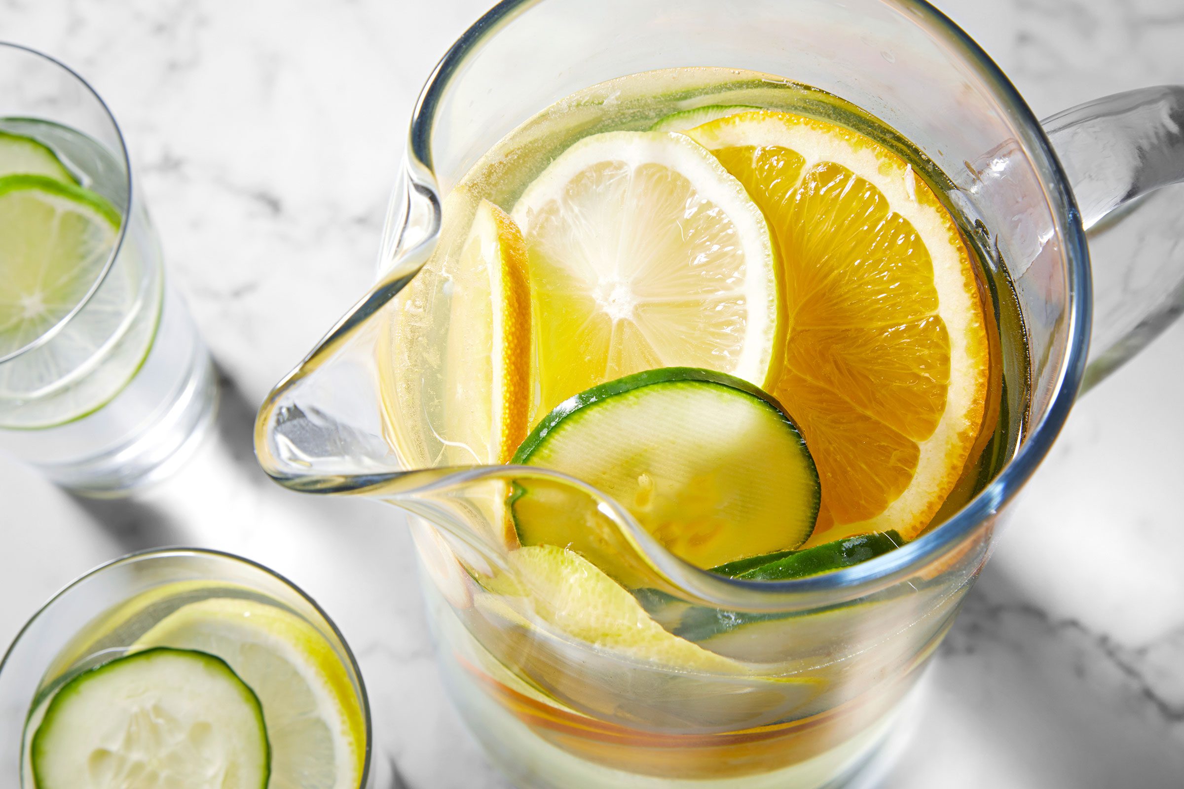 Cucumber Water in a glass jar with lemon, cucumbers and orange slices in it