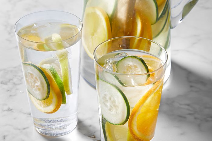 Cucumber Water served in two glass jars with lemon, cucumber and orange slices in it