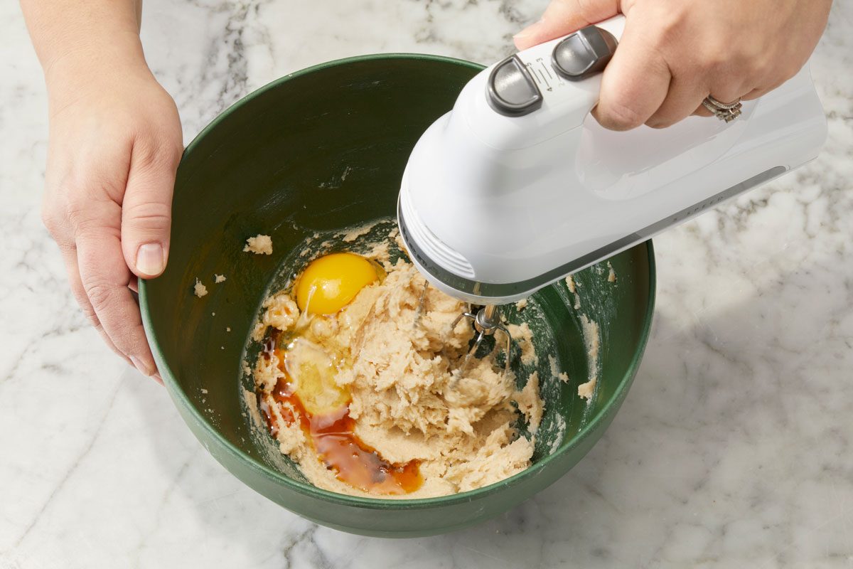 In a large bowl, cream butter and sugars. Beat in egg and vanilla.