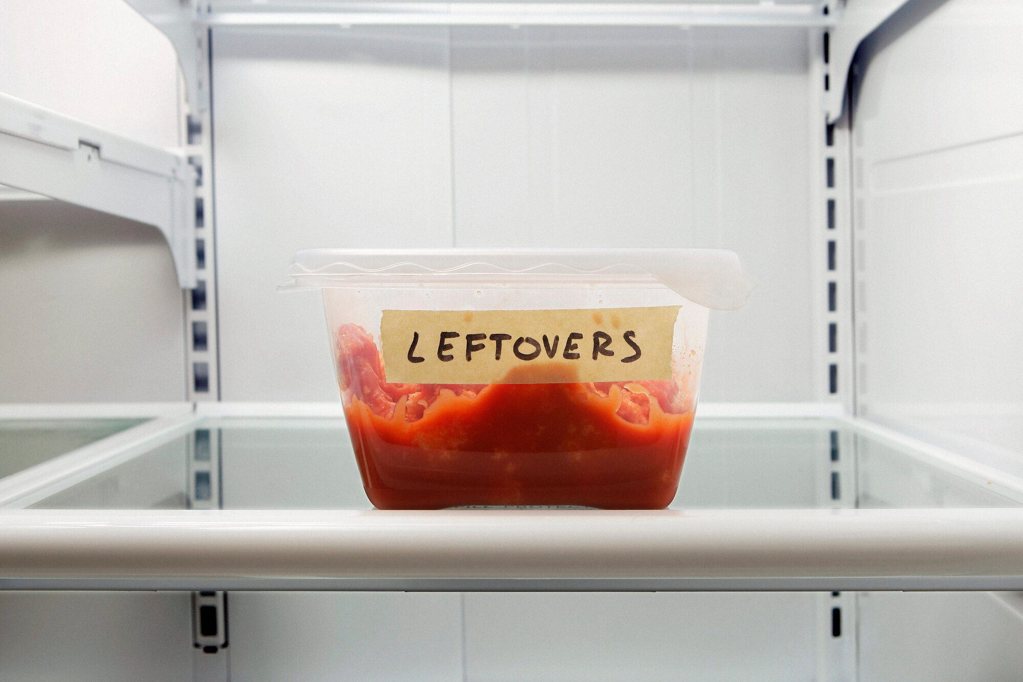 Single leftover container on refrigerator shelf