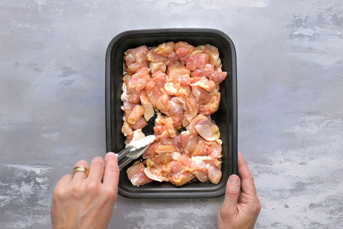 Deboned chicken cut into pieces and placed in a container