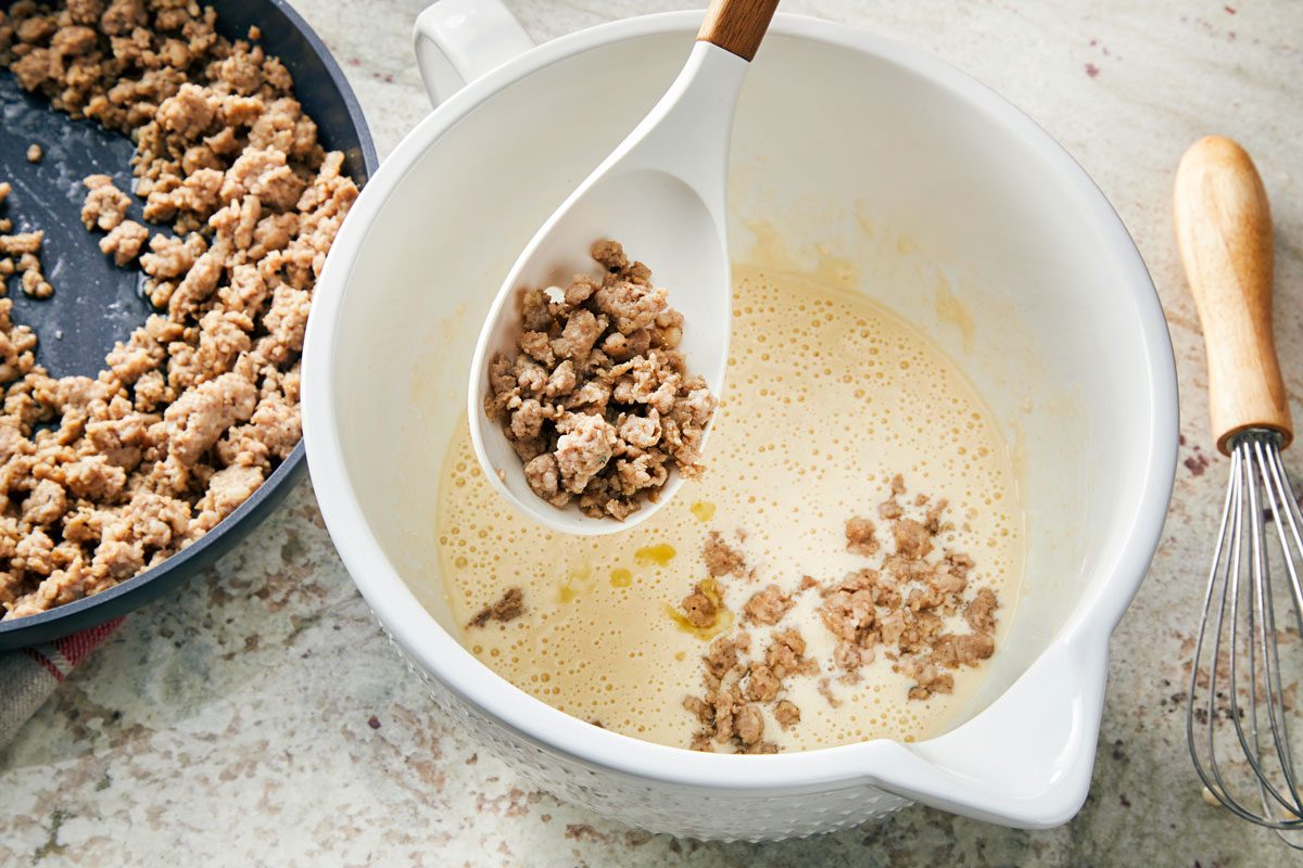 Mix biscuit mix; milk; eggs and oil until blended; stir in sausage