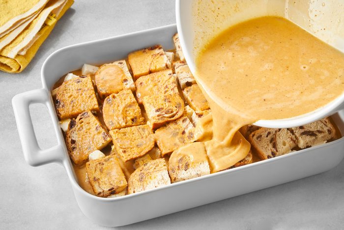 Baking dish filled with bread pudding; the bread pudding is topped with a golden custard