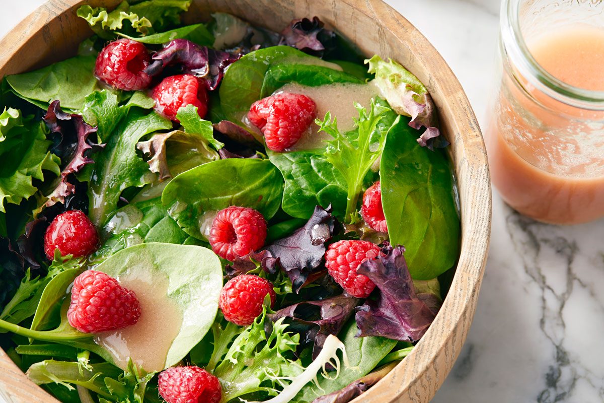 high angle shot of Raspberry Vinaigrette with salad