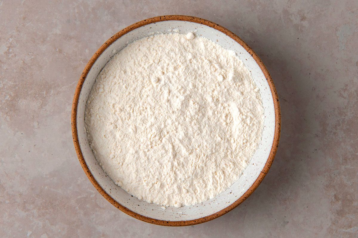 Overhead shot of Homemade Self-Rising Flour; in a bowl; marble surface;