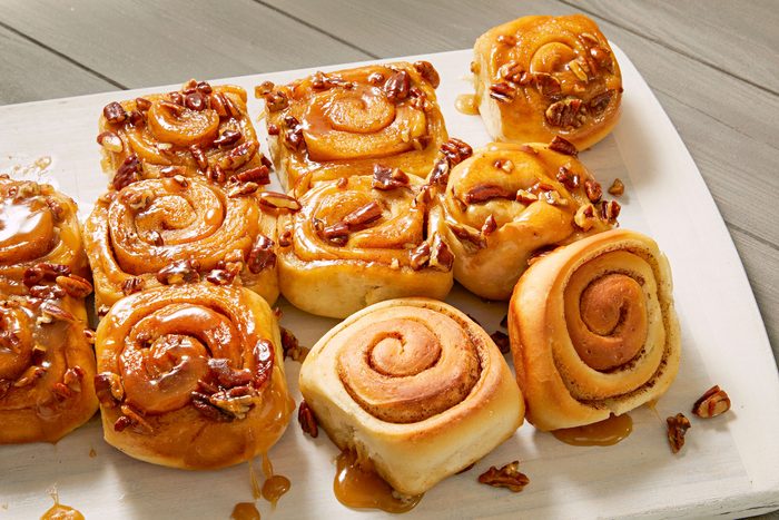 Sticky Buns cut into pieces and serve them on large platter placed on a wooden surface