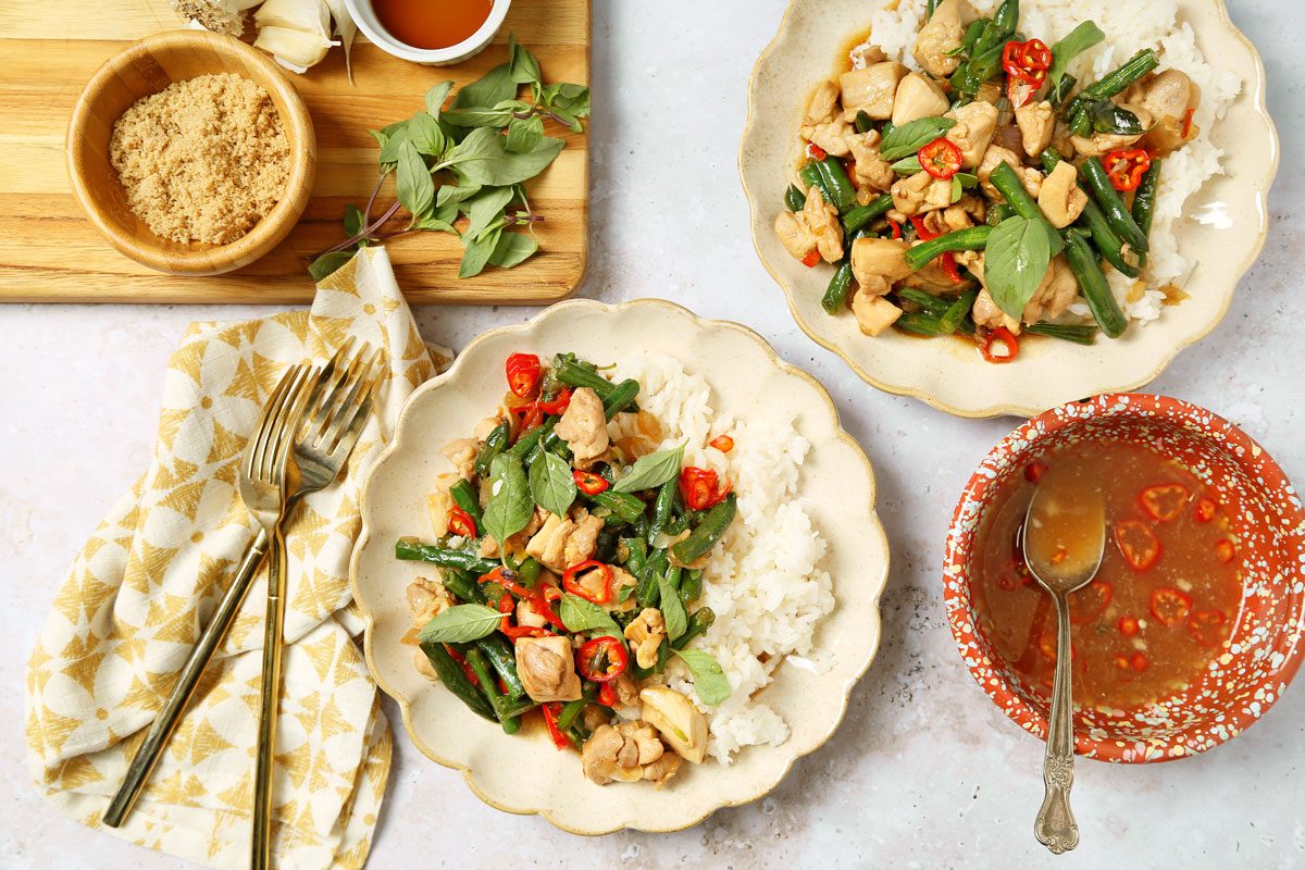 Thai basil chicken served on a plate with jasmine rice.