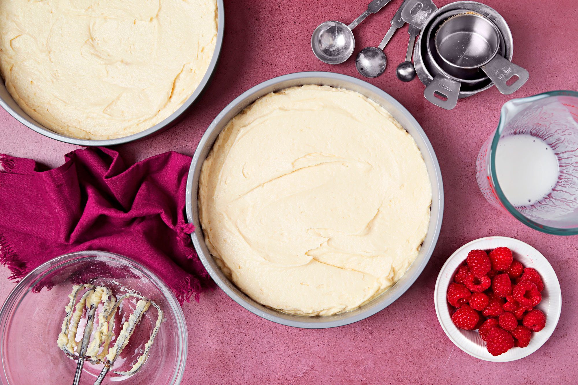 Cake batter poured into prepared cake pans.