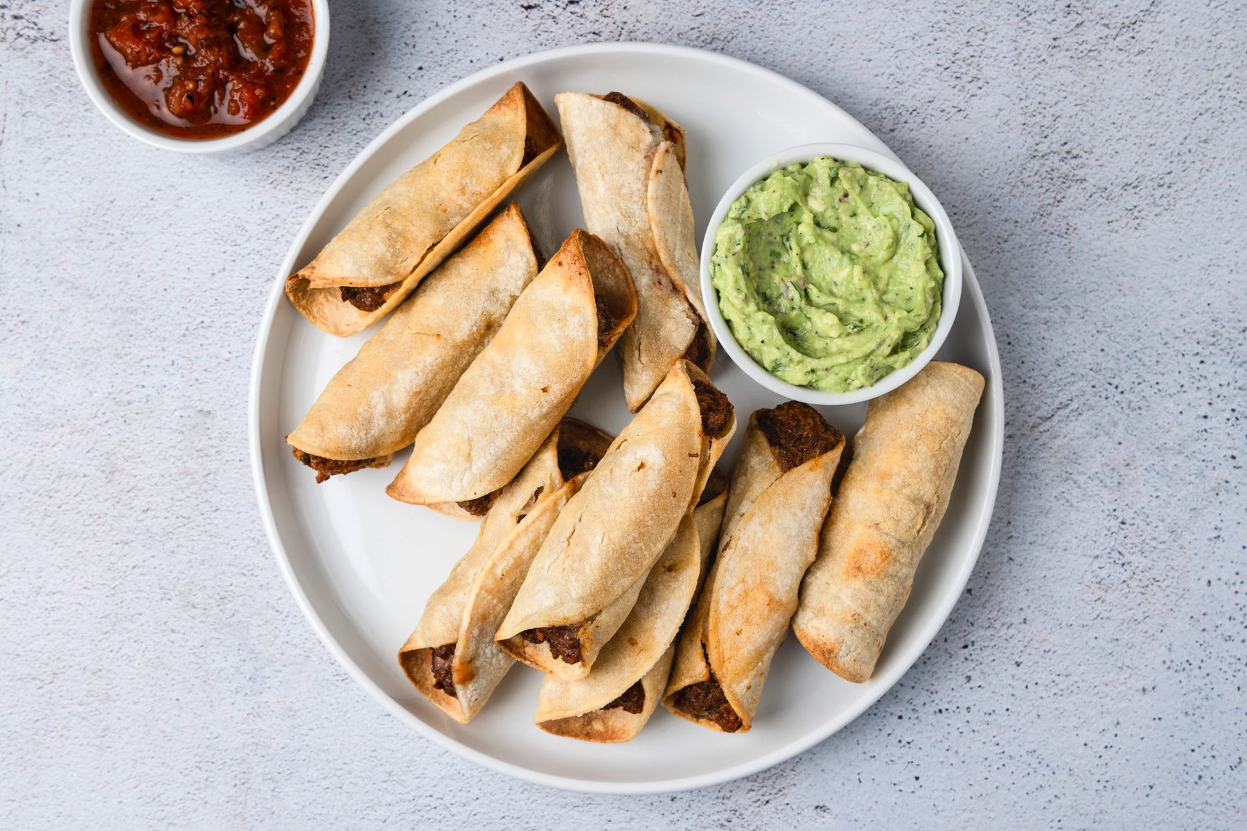Air Fryer Taquitos is ready and served in a plate.