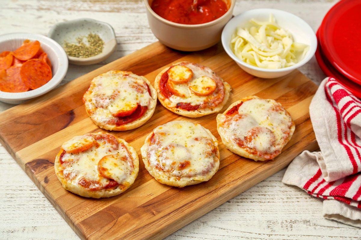 English Muffin Pizzas shot on a white wooden surface; overhead