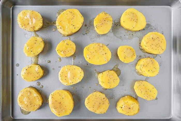 Cut potatoes arranged on a baking sheet