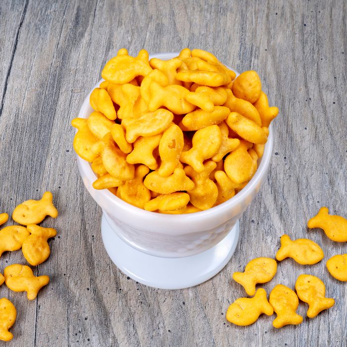 Orange cheddar flavored soup crackers in a white bowl