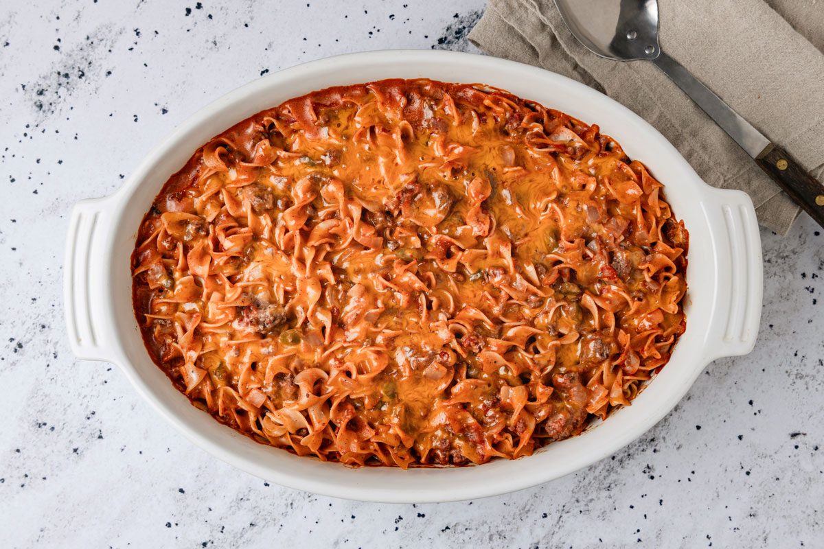 Overhead shot of Marzetti; in a baking pan; serving spoon; napkin; marble surface;